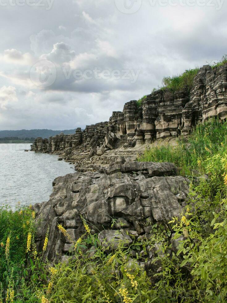 A view of a large pile of stones on the coast photo