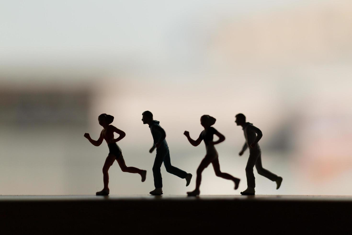 Silhouette of miniature people running, health and lifestyle concept photo