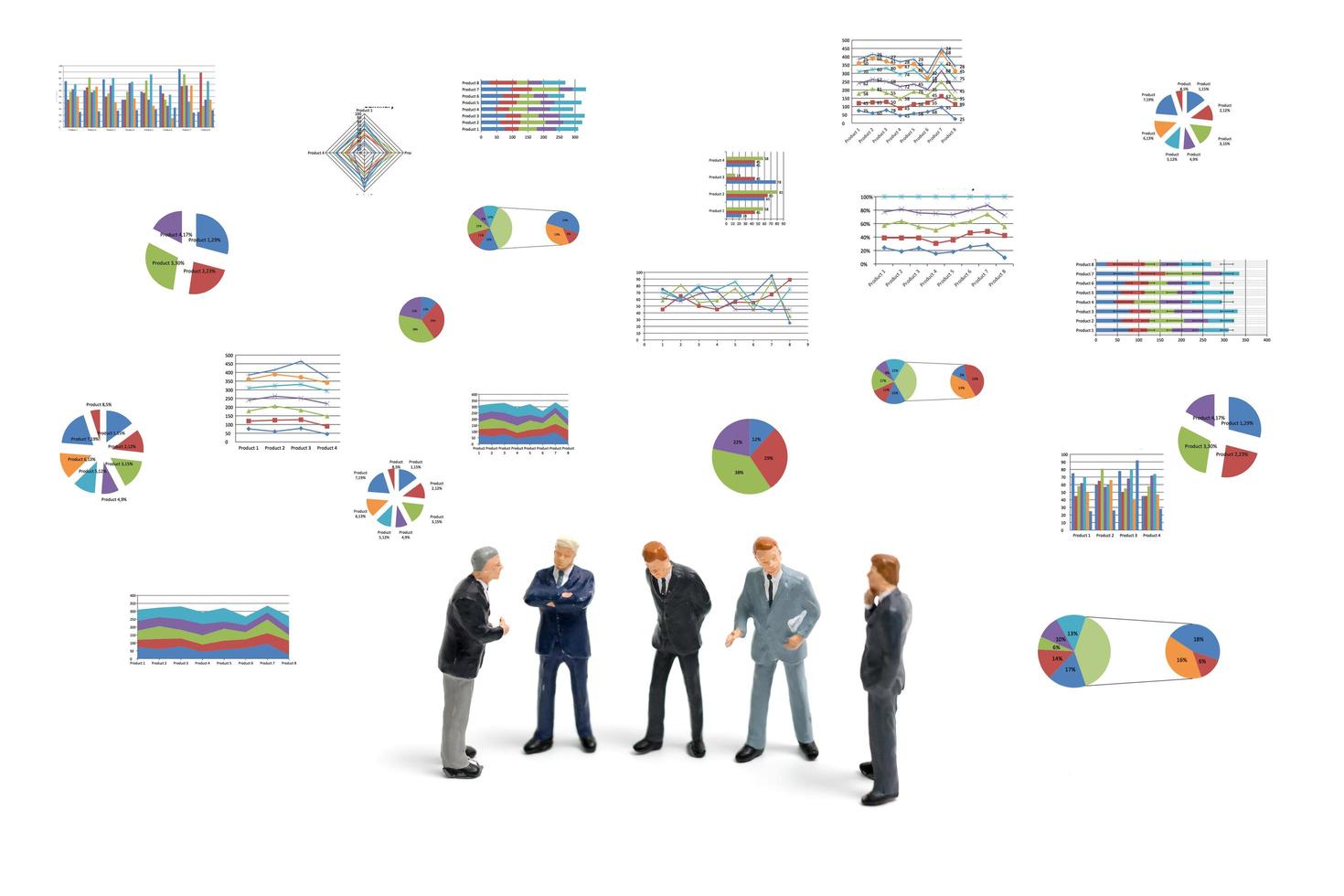 Miniature businessmen standing with charts on a white background photo