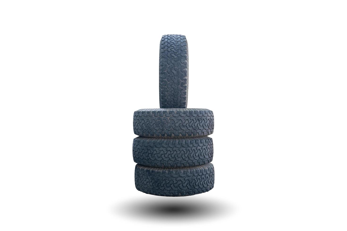 One vertical car tire stacked on three horizontal tires isolated on a white background photo