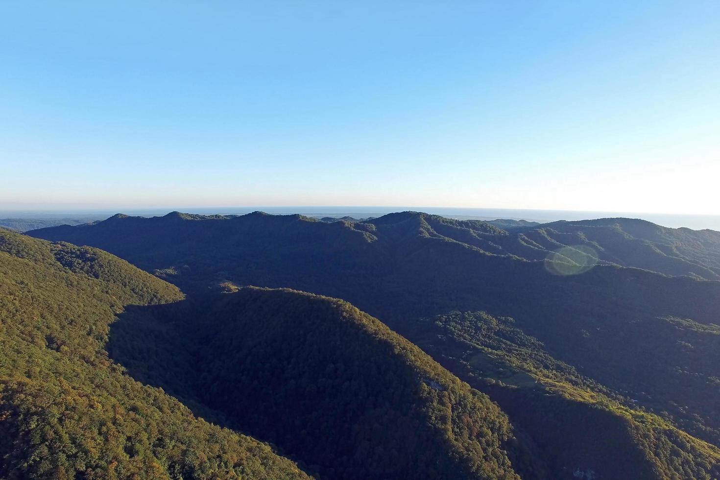 vista aérea de un paisaje de montaña con un cielo azul claro foto