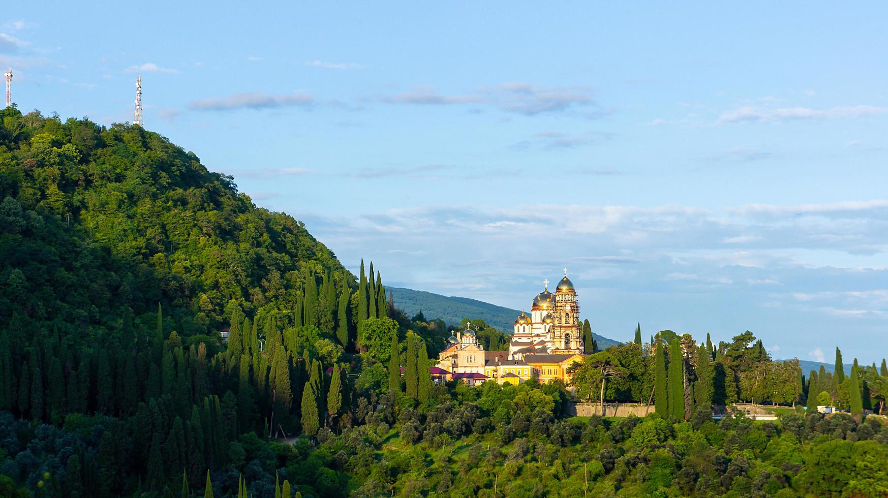 Landscape with a view of the New Athos Monastery with cloudy blue sky in Abkhazia, Georgia photo