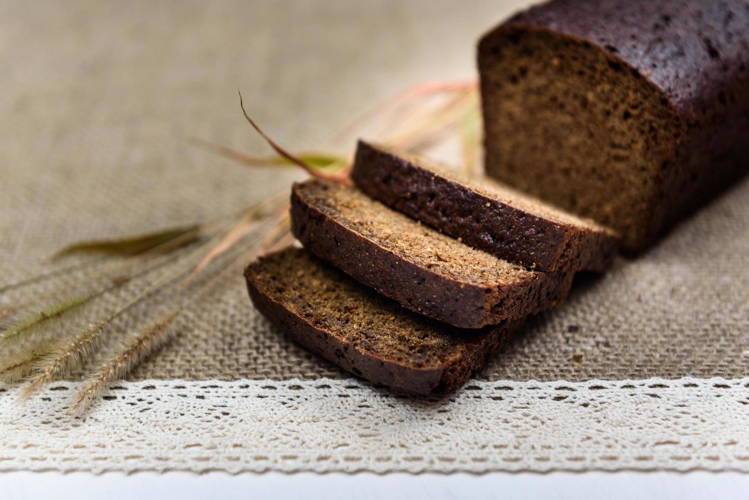 Black whole grain bread sliced on the table photo