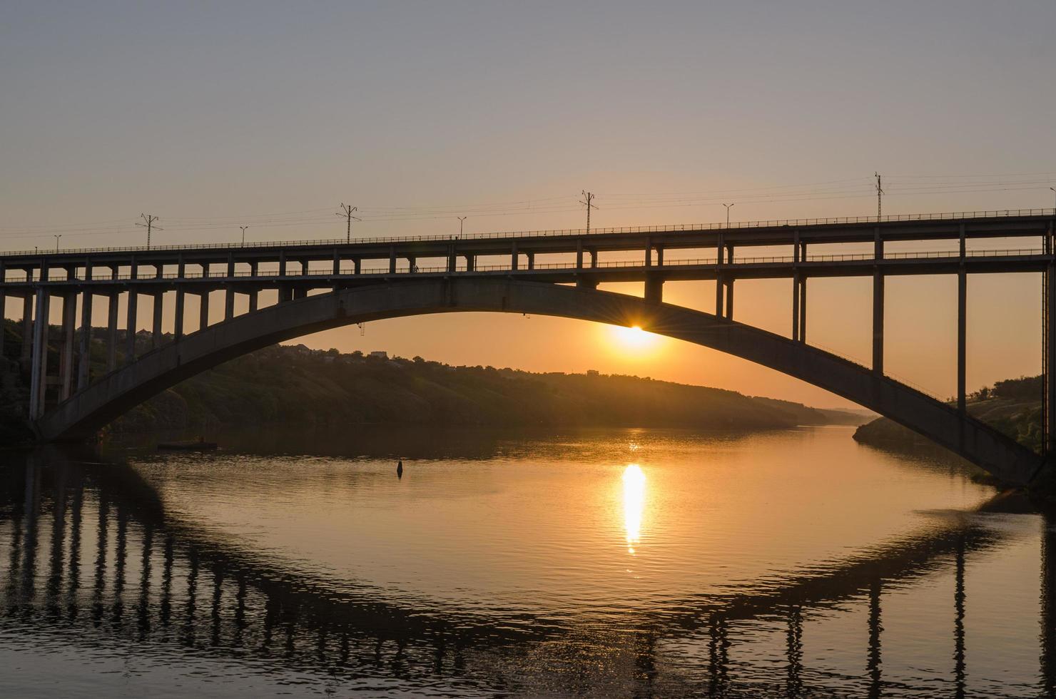 Road and rail split-level bridge over the river photo