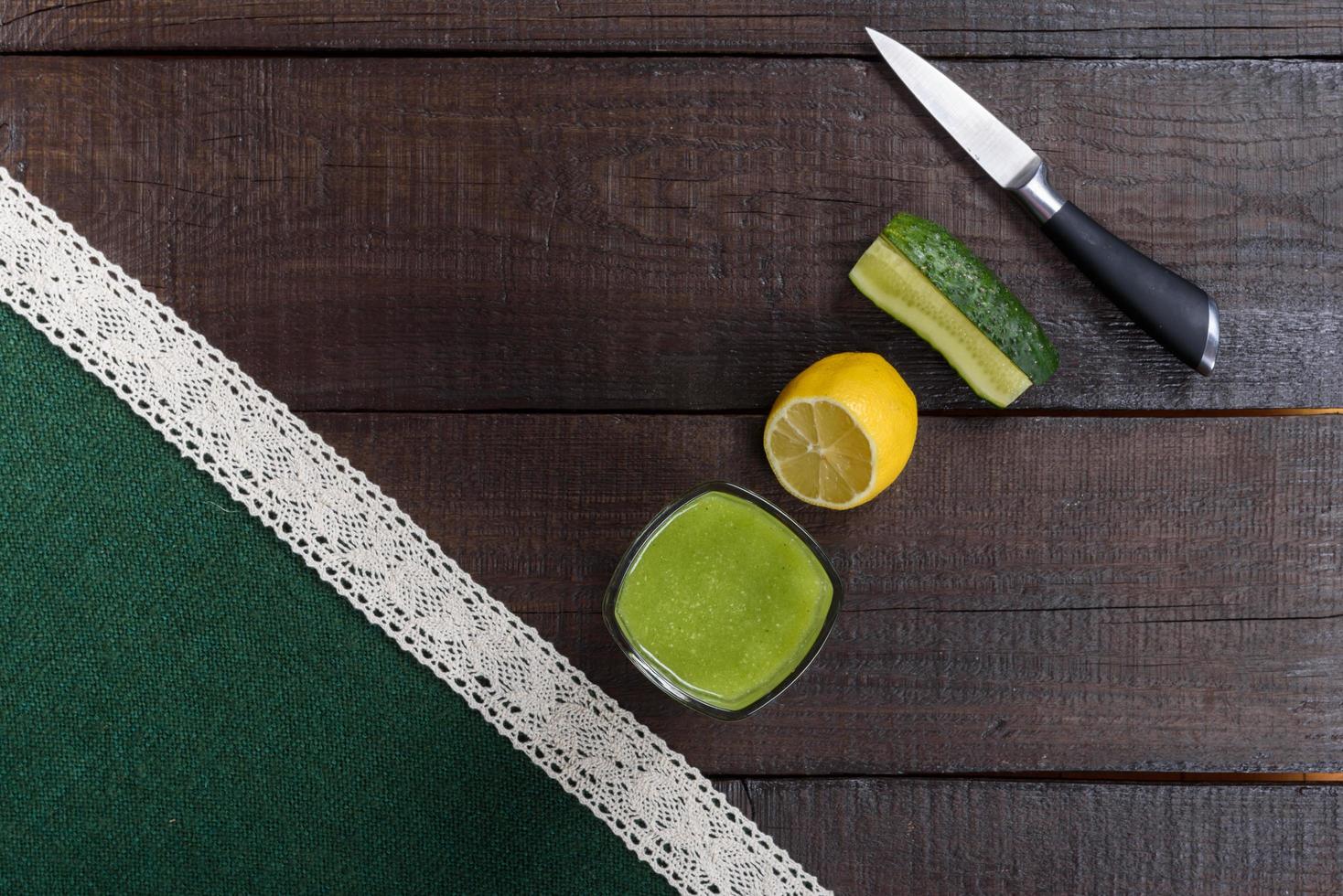 Cucumber smoothie on brown table photo