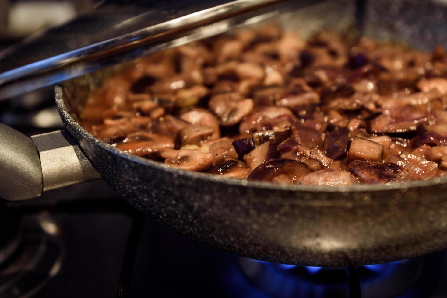 Cooking fried mushrooms in a pan photo