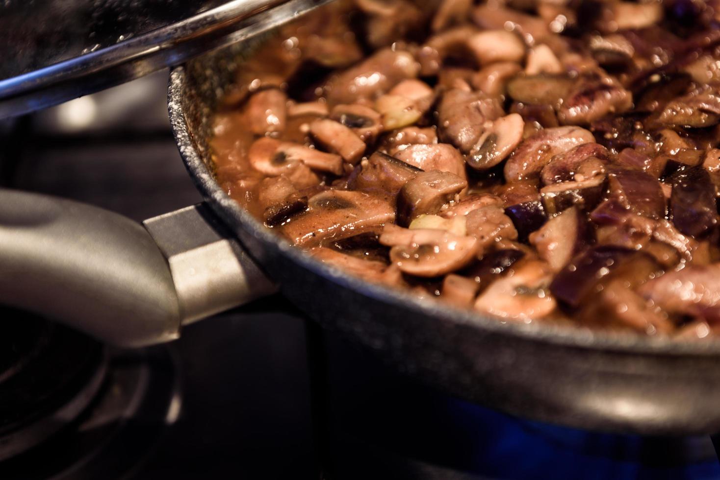 Cooking fried mushrooms in a pan photo