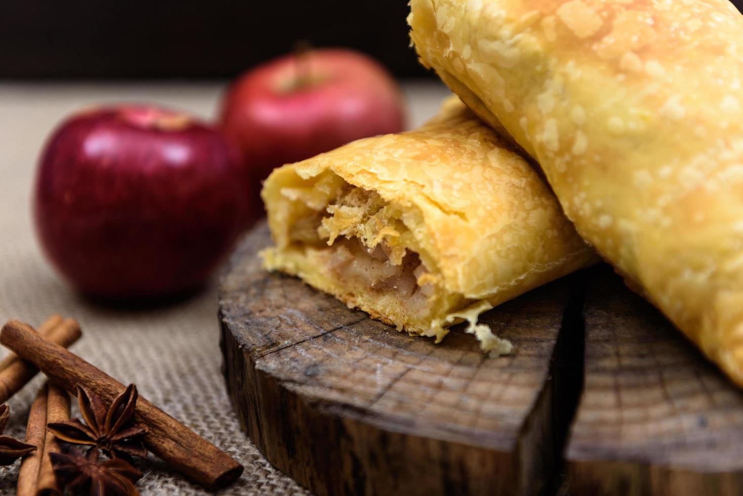 Apple strudel on wooden end of a tree photo