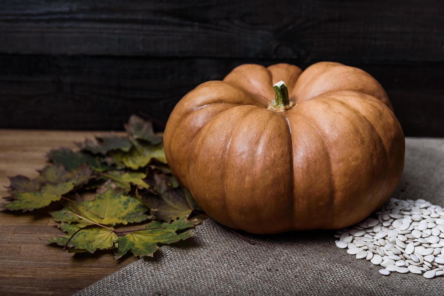 Pumpkin lying on a wooden table photo