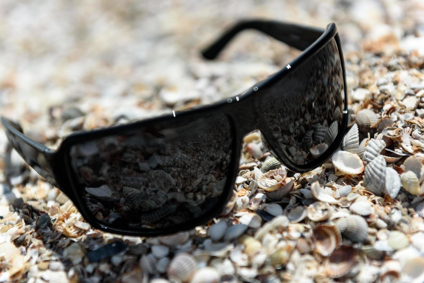 Sunglasses on the seashore photo