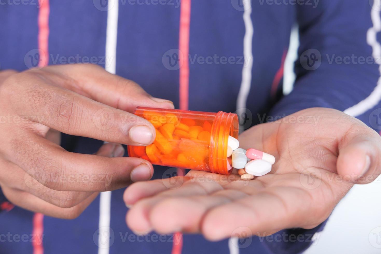 Man's hand with medicine photo