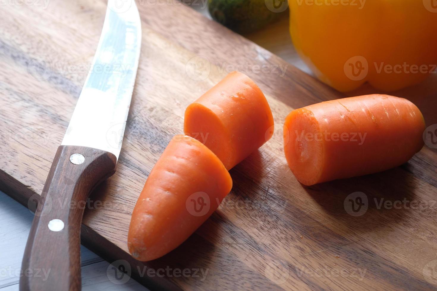 Fresh chopped carrots on chopping board photo