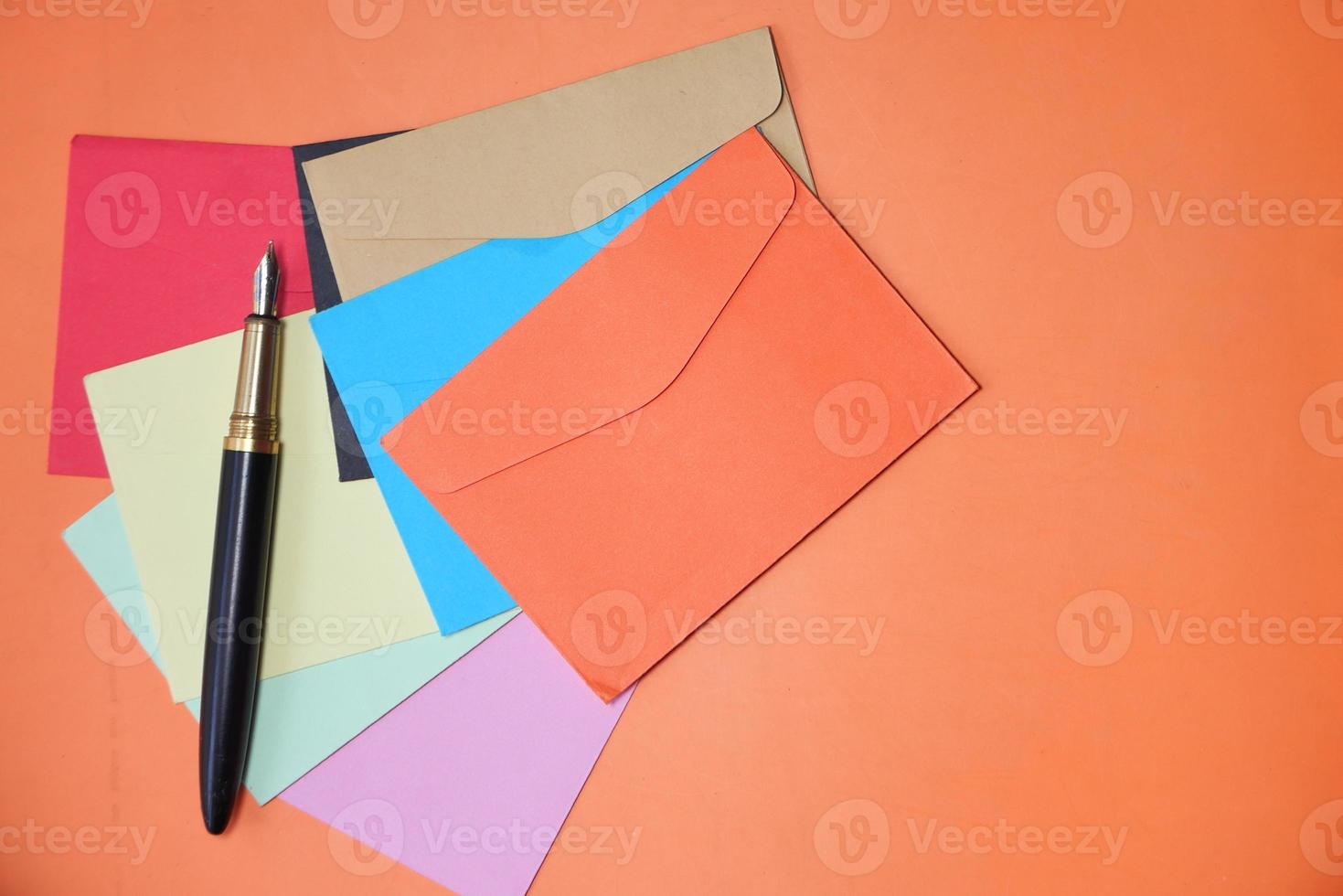 Colorful envelope on orange background with copy space photo