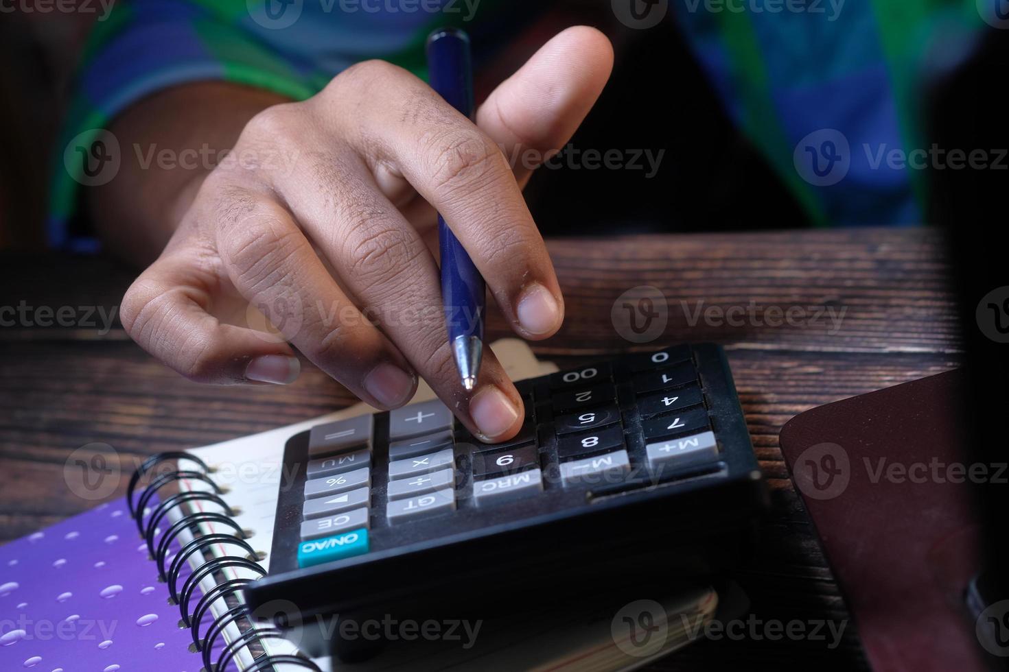 Person using a calculator photo