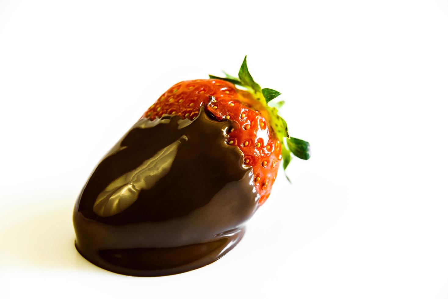 Strawberries with a tail drenched in liquid chocolate photo