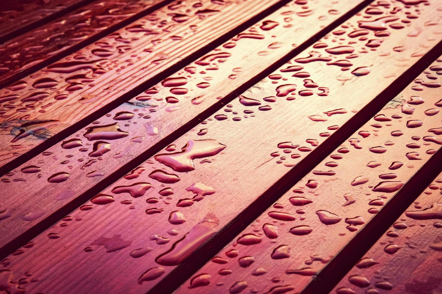 Drops of water on red wood photo