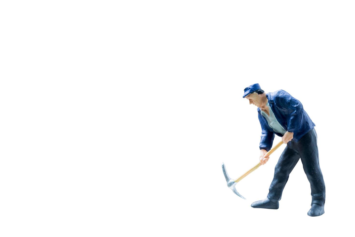 Miniature construction worker on isolated on a white background photo