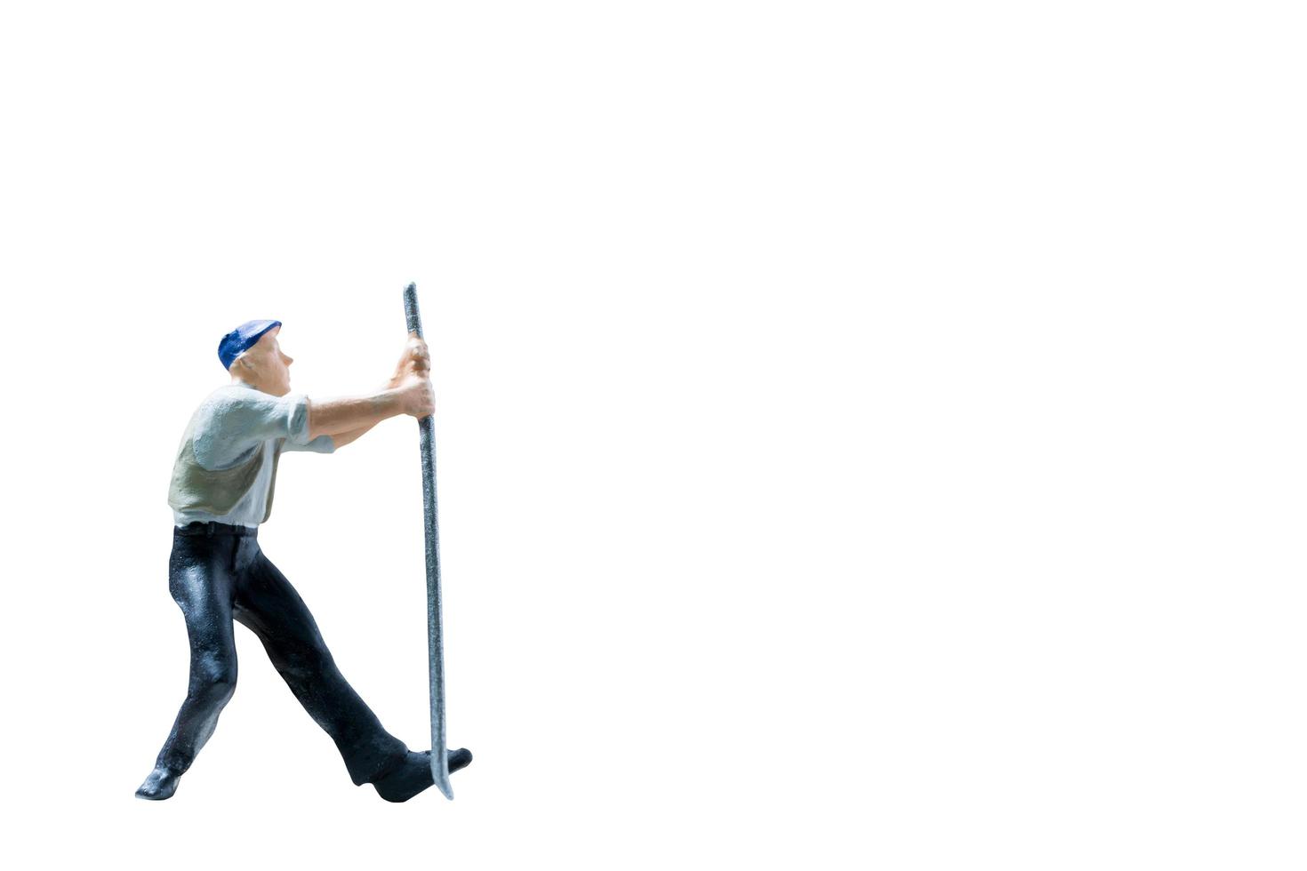 Miniature construction worker on isolated on a white background photo