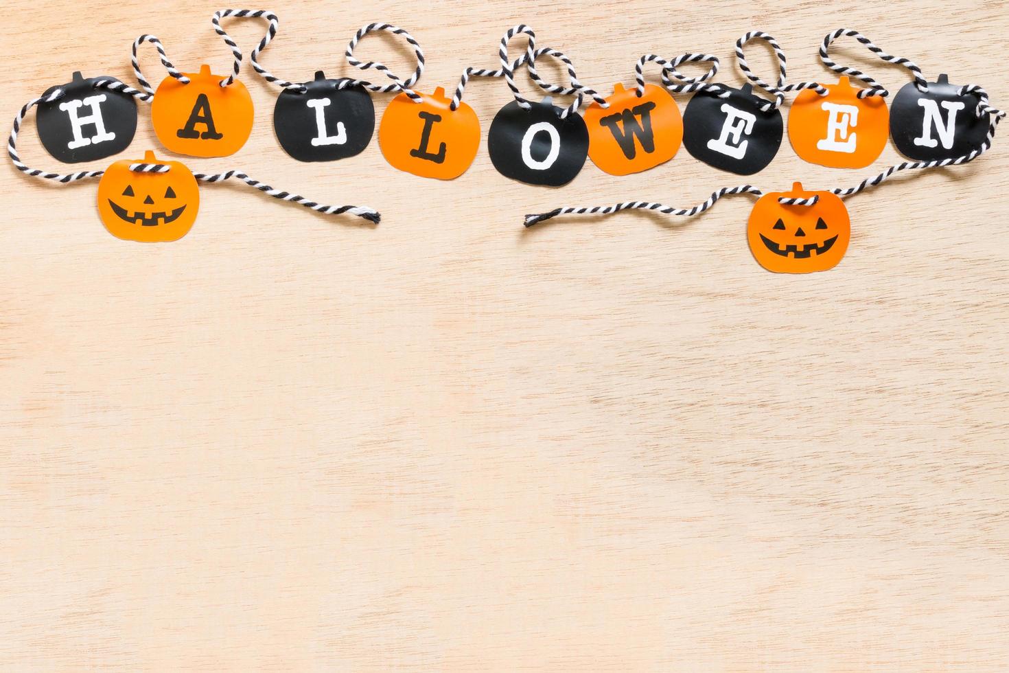 Halloween decoration, black and orange flags on a wooden background photo