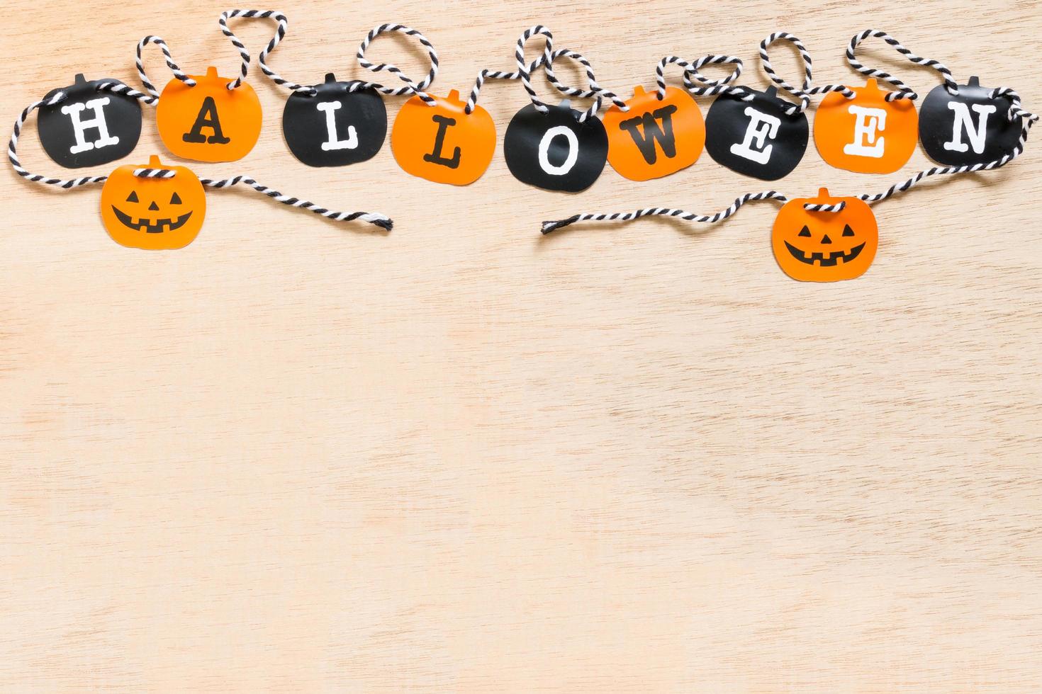 Halloween decoration, black and orange flags on a wooden background photo