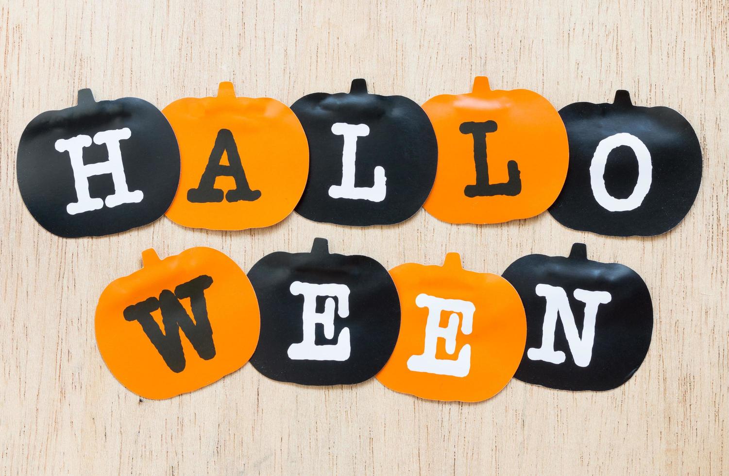 Halloween decorations, black and orange pumpkins on a wooden background photo