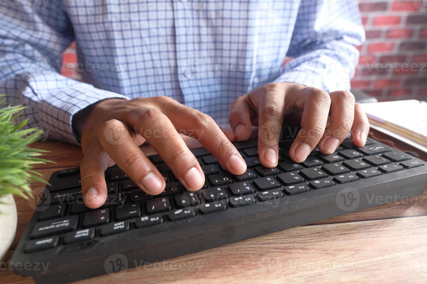 Close up of man hand typing on keyboard photo