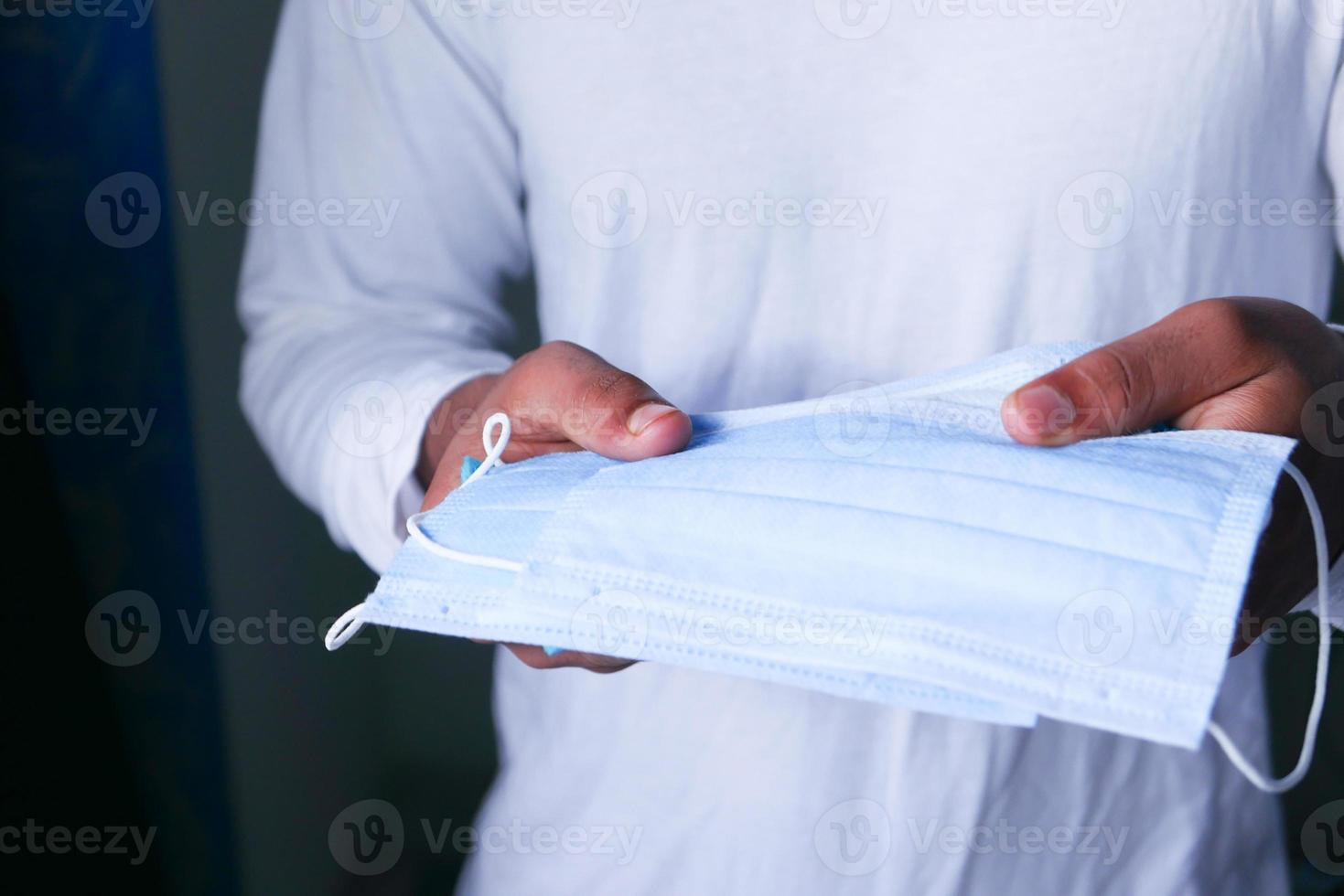 Man holding protective face masks photo