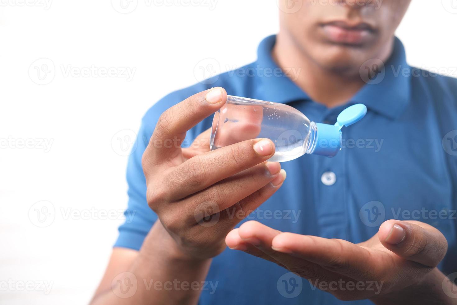 Using sanitizer liquid isolated on white background photo