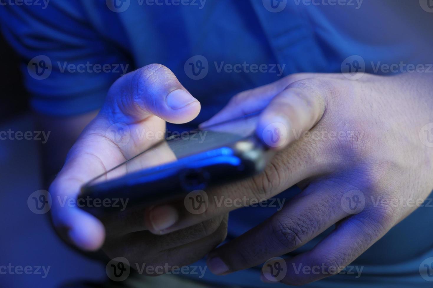 Close up of a young man using smart phone photo