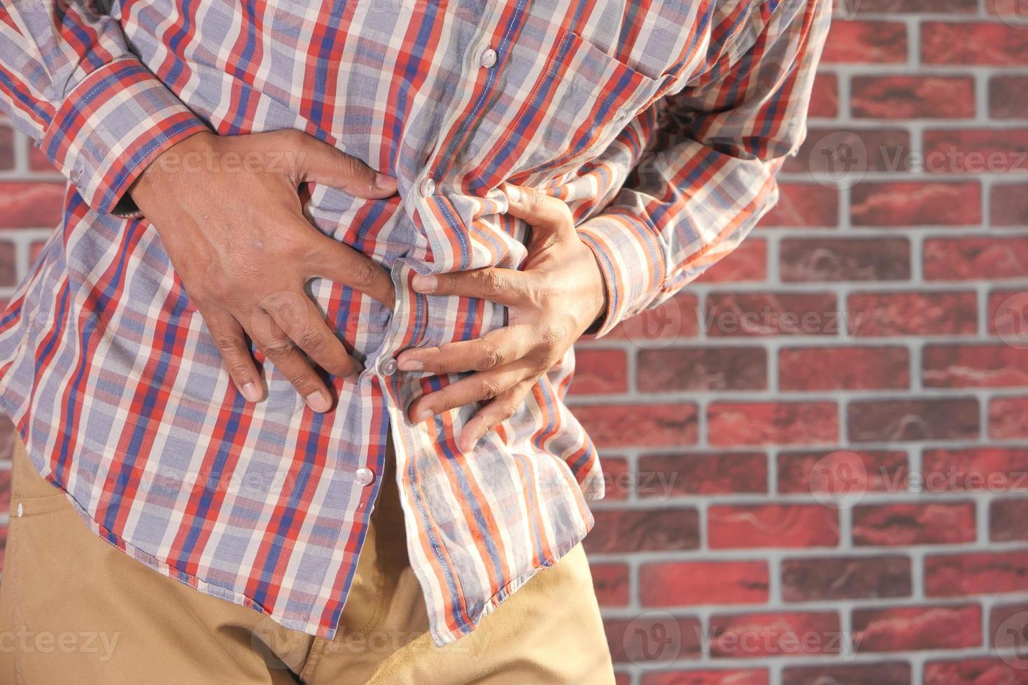 Young man suffering stomach pain photo