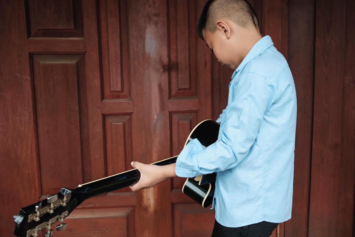 Boy holding a guitar photo