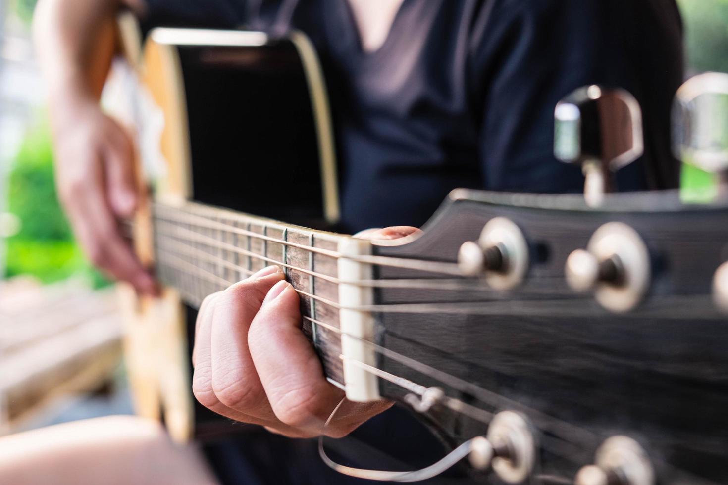Close-up of a person playing a guitar photo