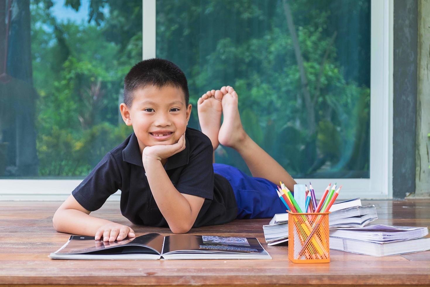 Boy posing with learning materials photo