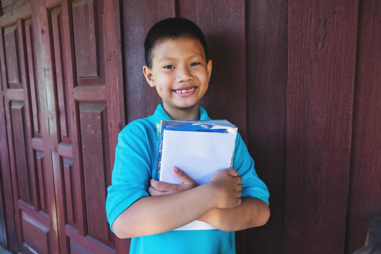 Boy hugging books photo