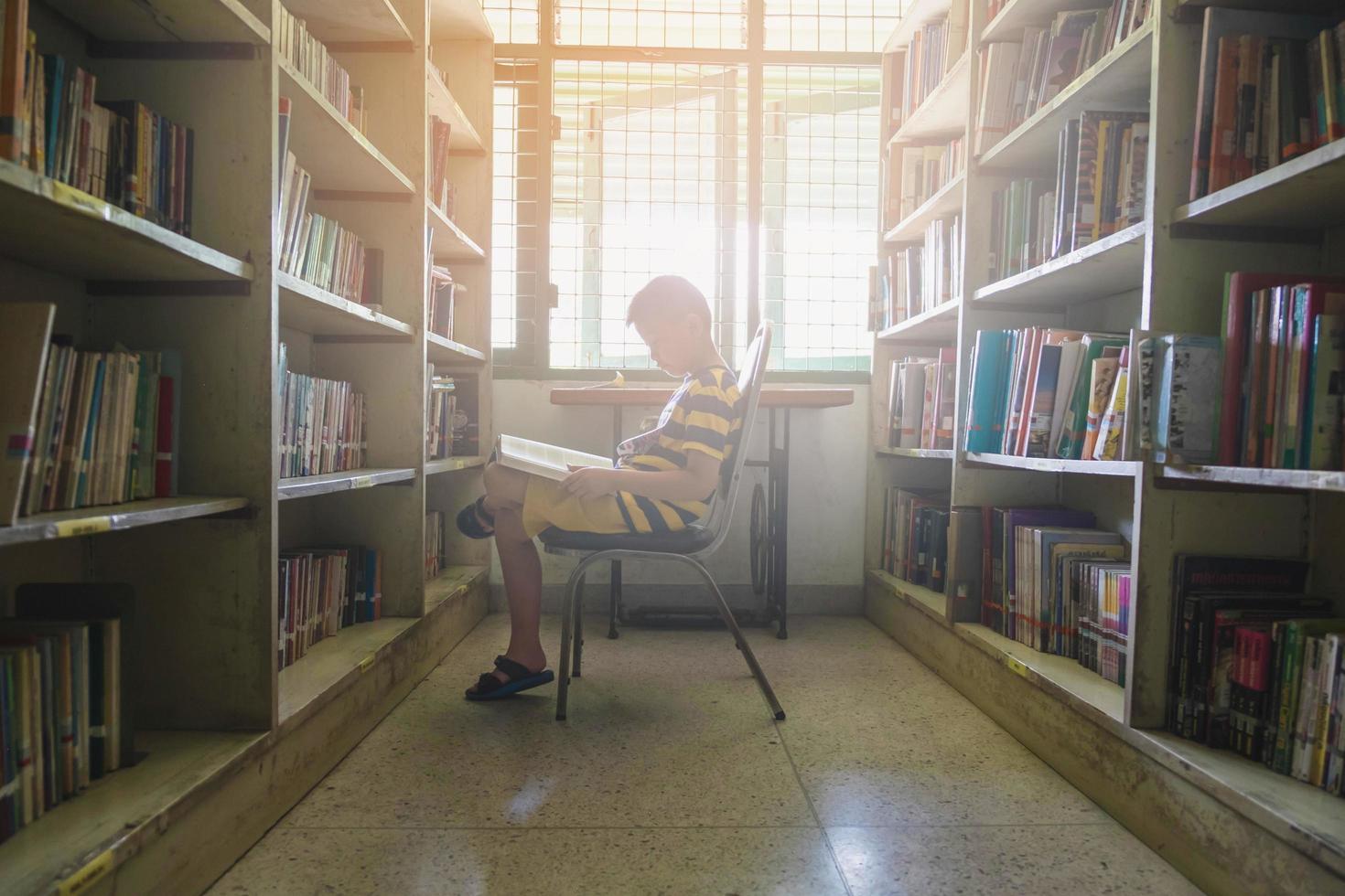 Boy reading in sunlight photo