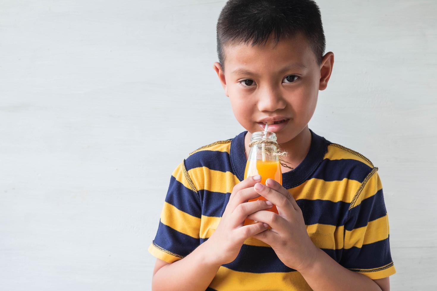 Boy drinking juice photo