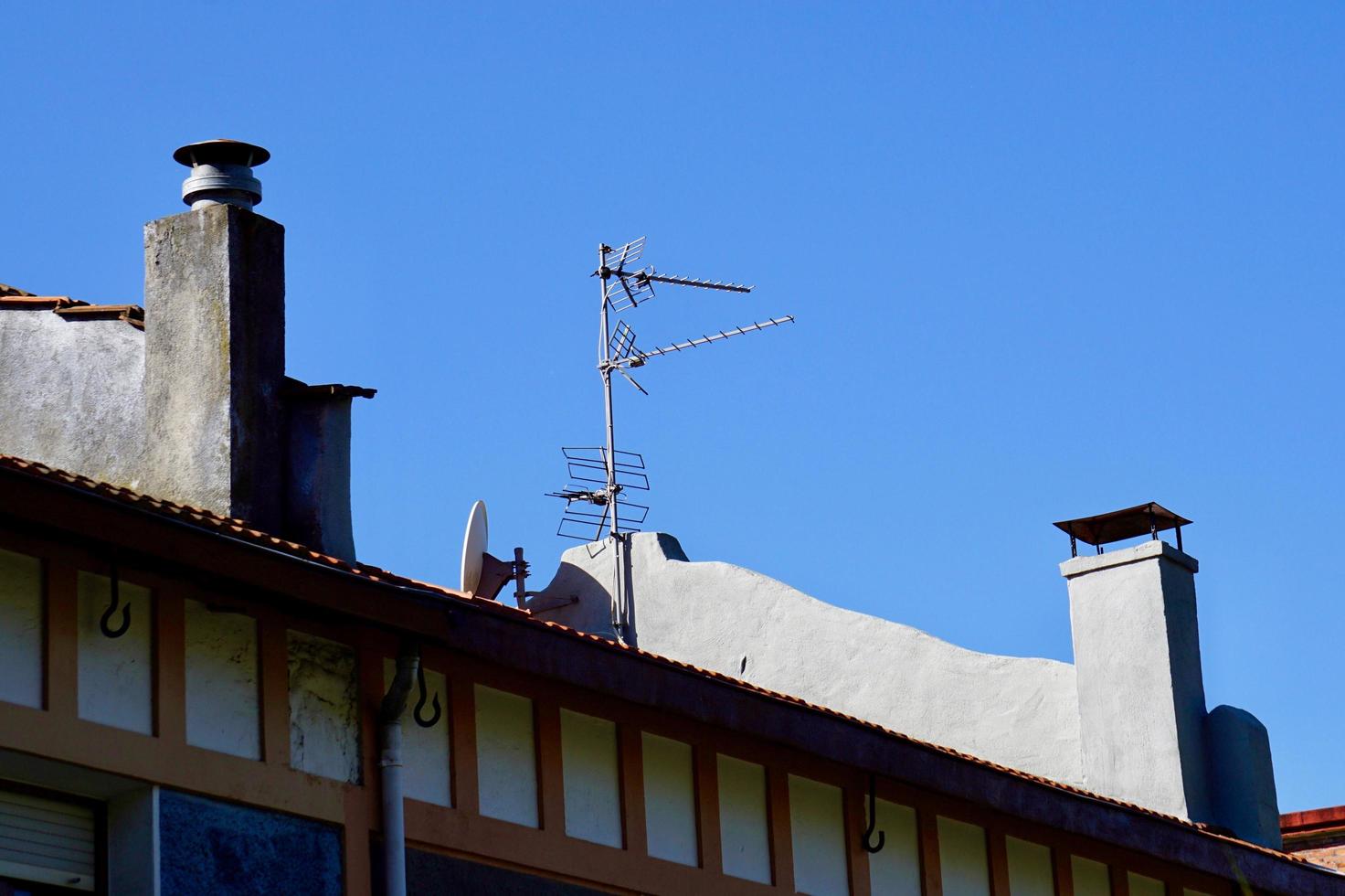 TV antenna on a rooftop of a house photo