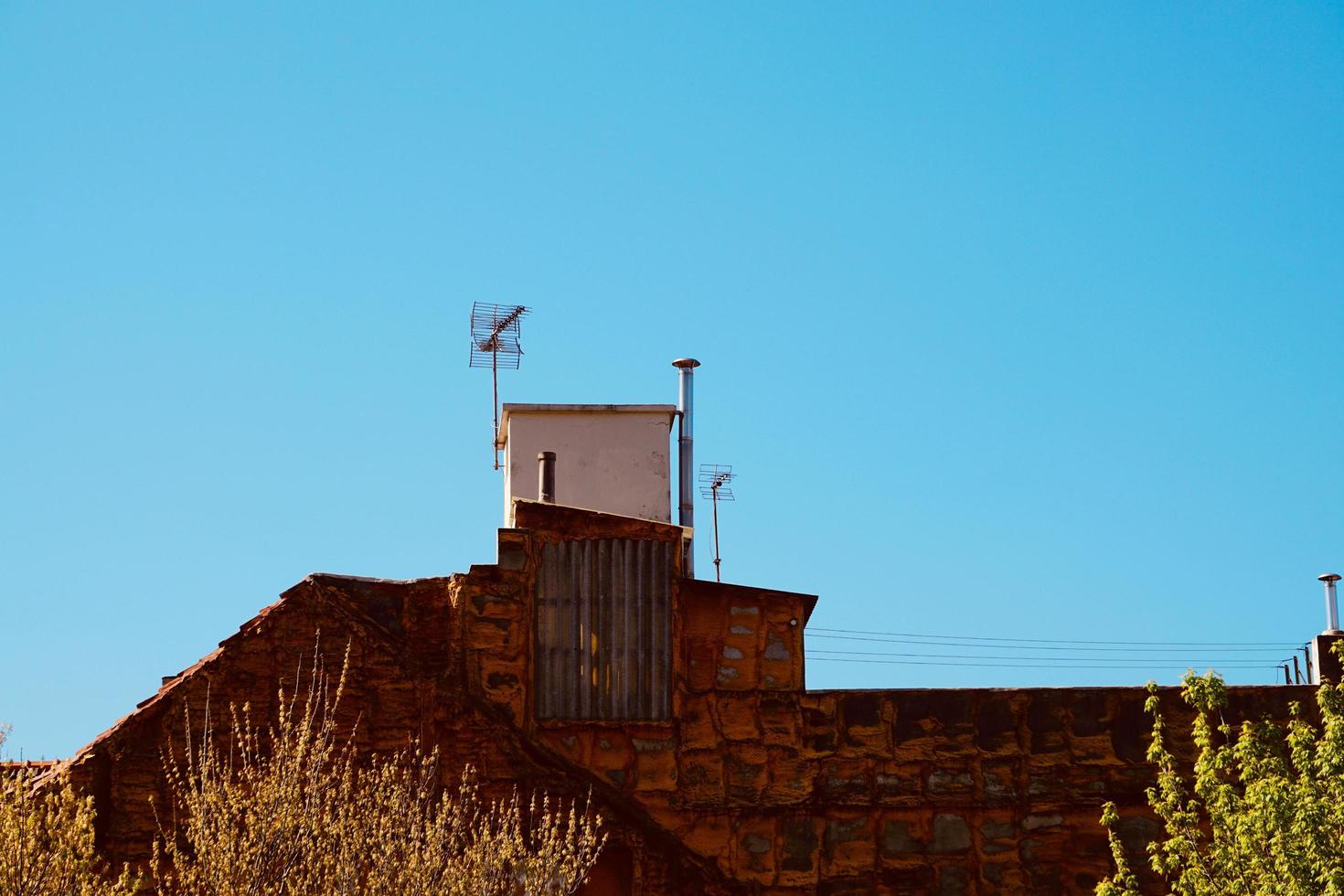 antenna tv on the rooftop of the house photo