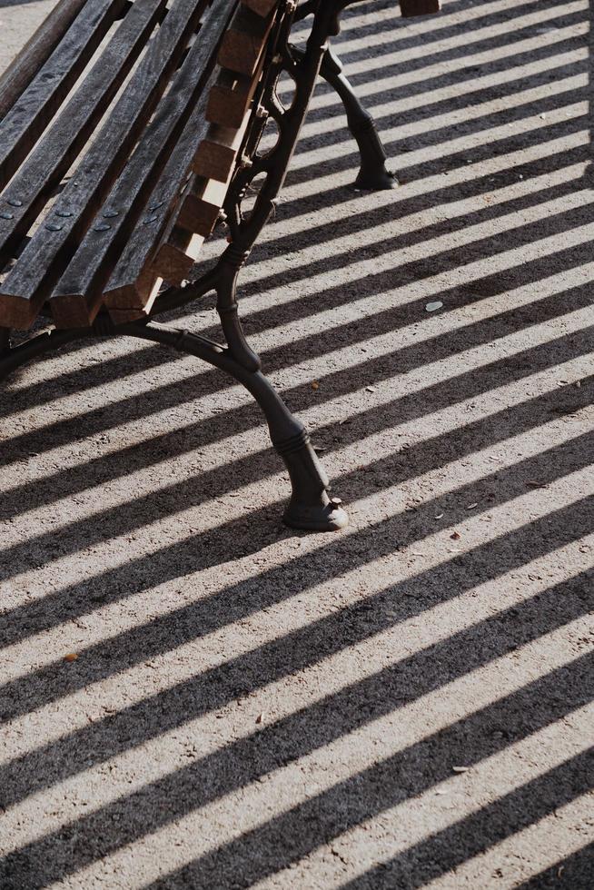 Wooden bench on the street in a city photo