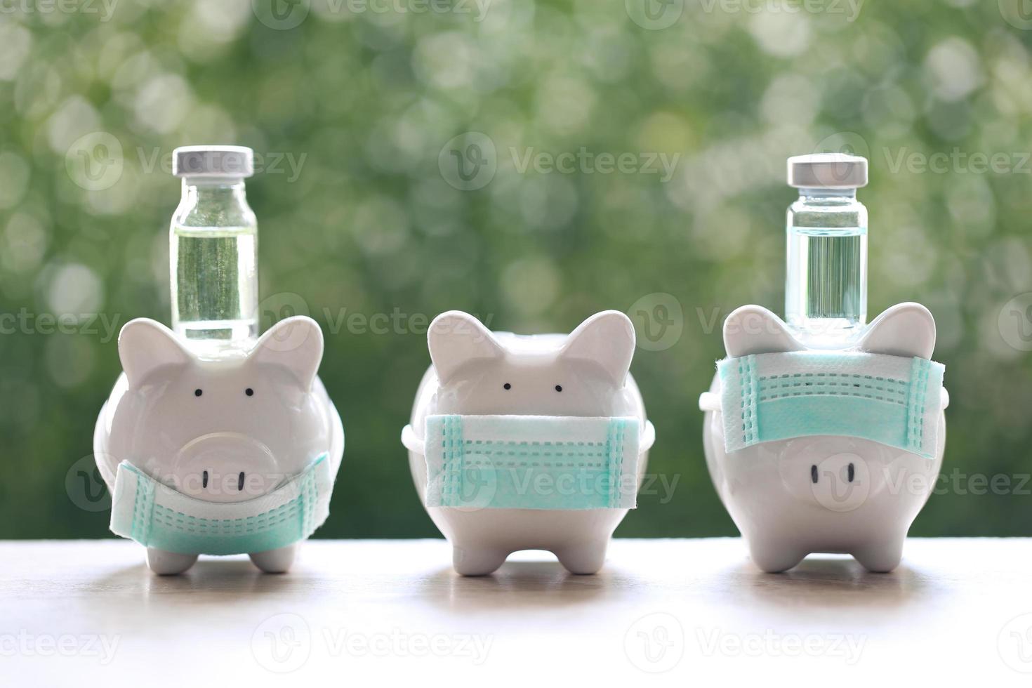 Piggybanks showing how to wear protective medical masks correctly to protect from smog or viruses with medicine bottles on a natural green background, medical insurance and health care concept photo