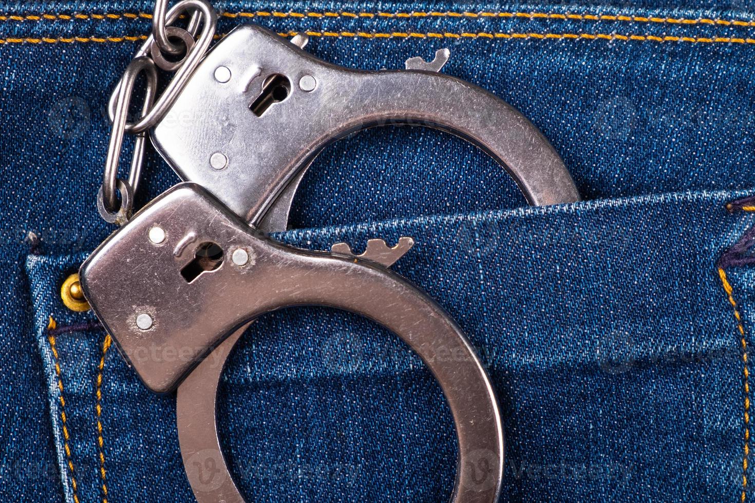 Handcuffs in the back pocket pants photo