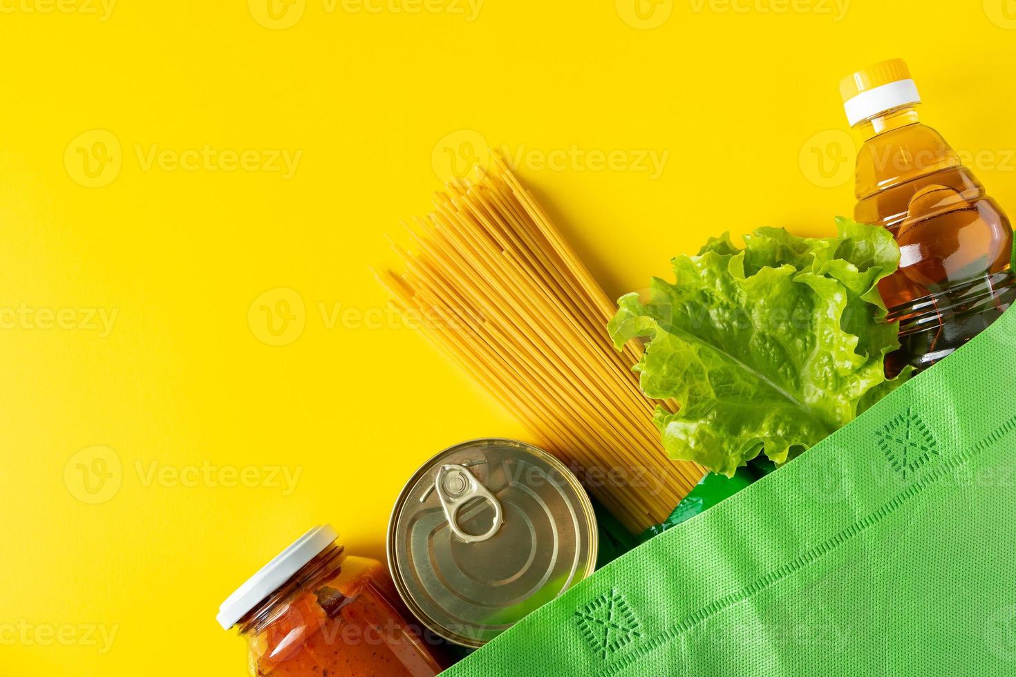 Delivery of necessary food during quarantine. Donation foodstuffs on a yellow background. photo