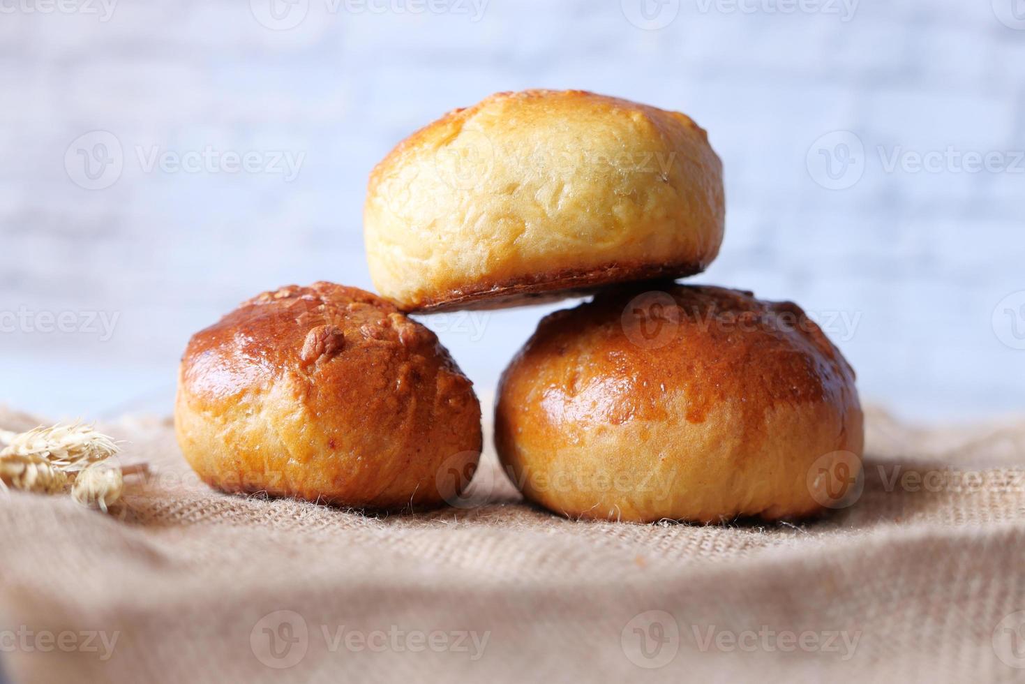 Stack of baked rolls on table photo