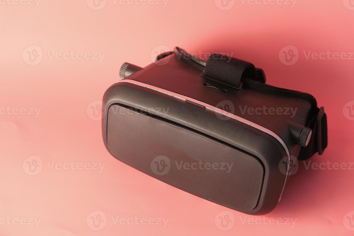 Close up of VR headset on pink background photo