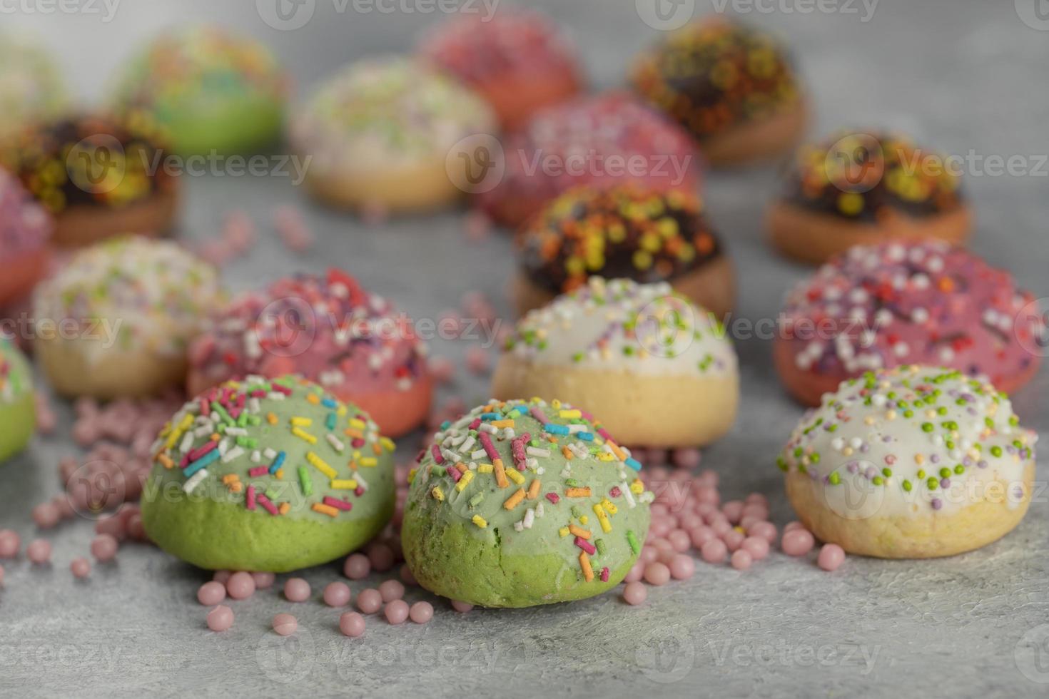 Colorful sweet small doughnuts with sprinkles photo