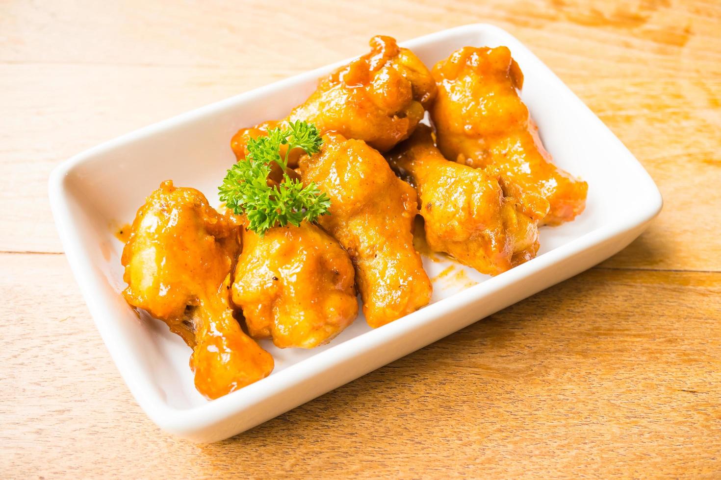 Grilled buffalo wings in white plate photo