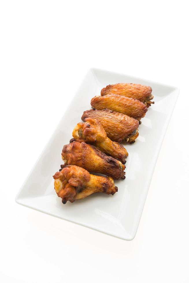 Grilled chicken wing in white plate photo
