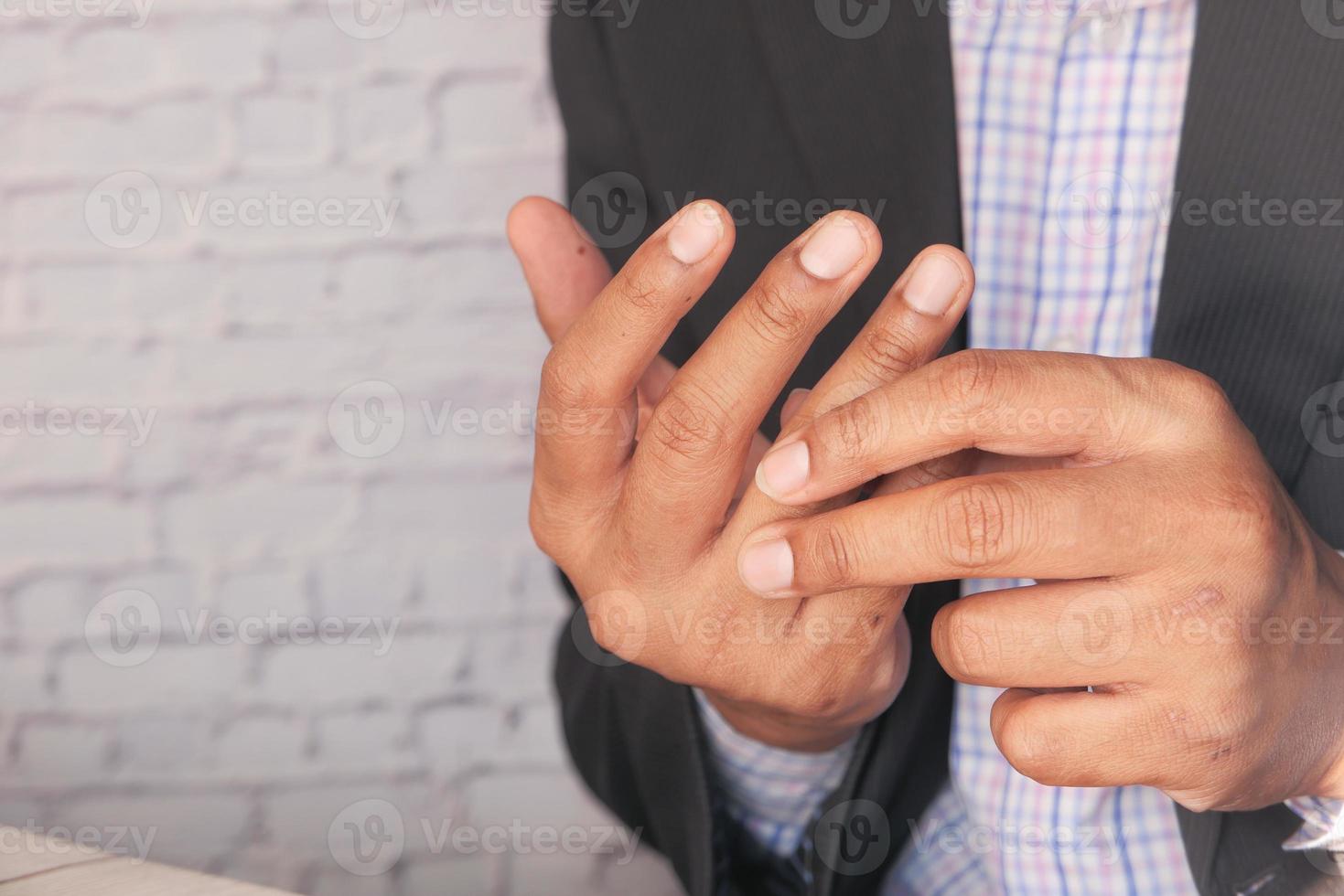 Man with pain in the fingers close up photo