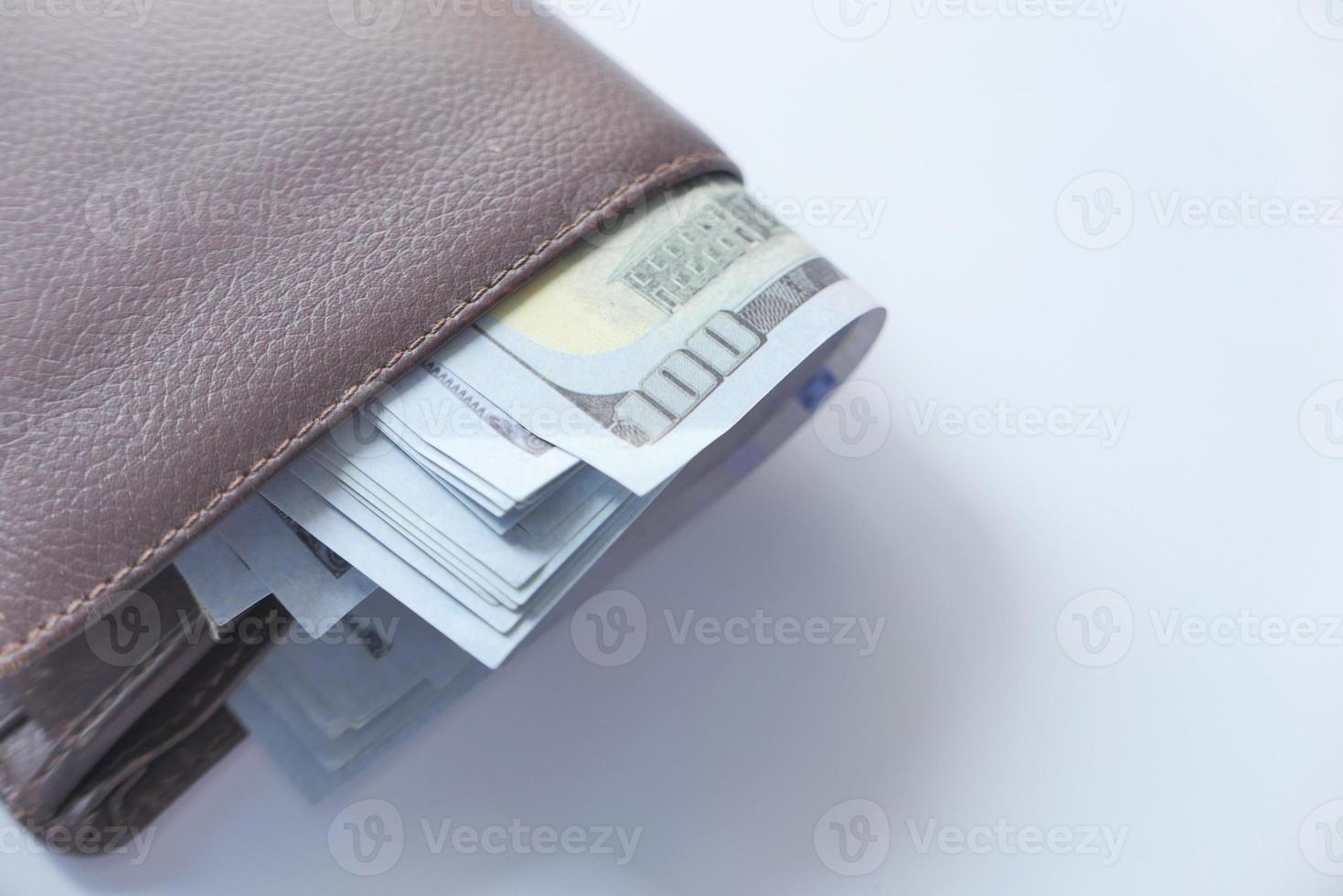 Close up of cash in wallet on table photo