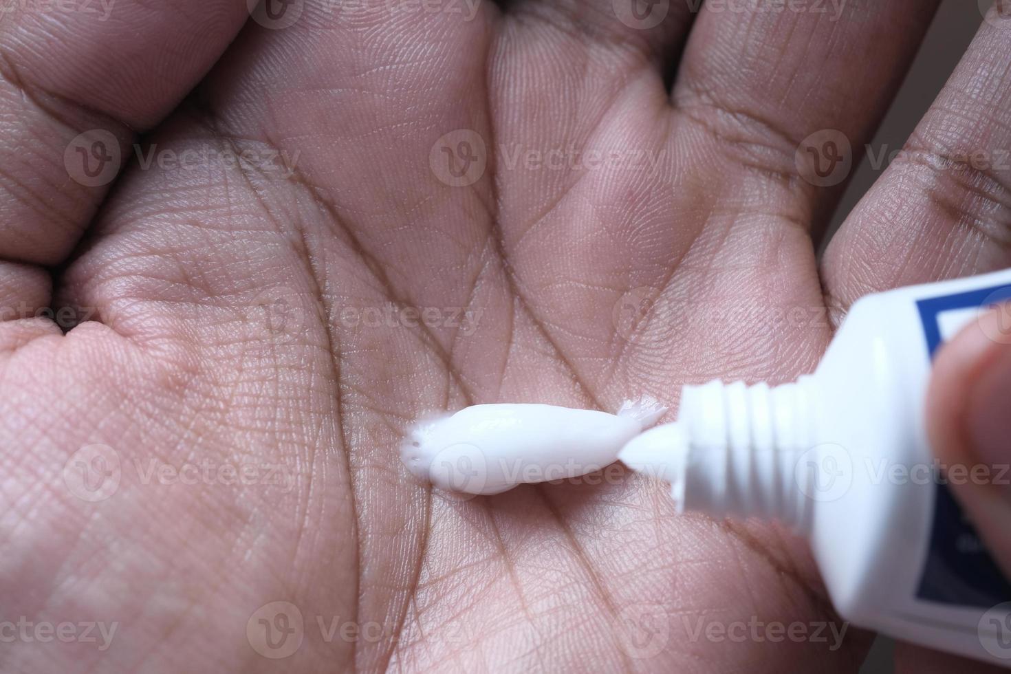 Close up of person using hand cream photo